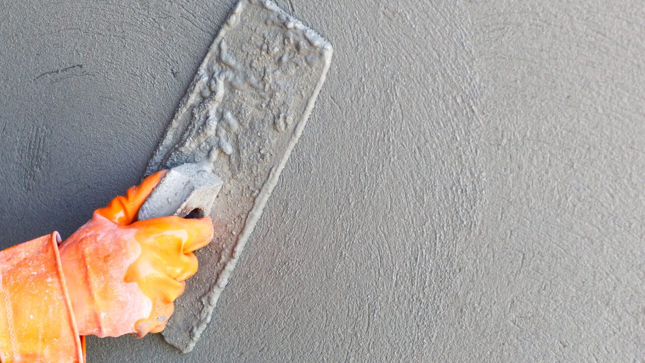 Construction worker standing next to an exterior wall